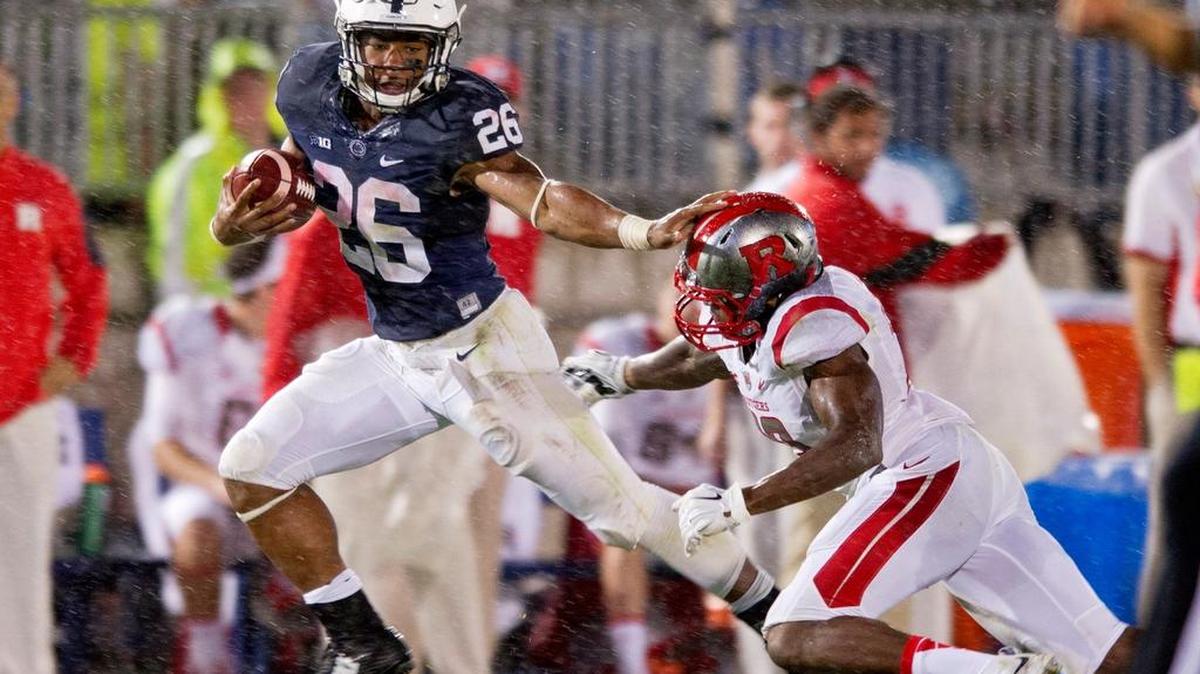 Penn State running back Saquon Barkley stiff arms Rutgers defensive back Davon Jacobs last season.