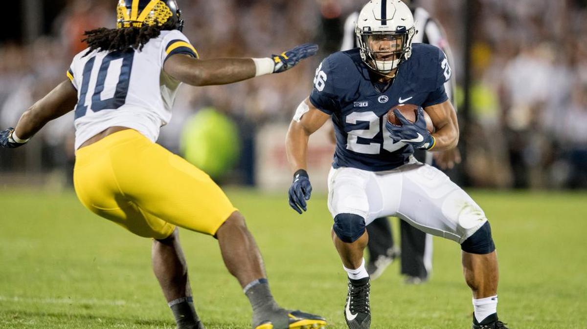 Penn State running back Saquon Barkley cuts around Michigan linebacker Devin Bush during the first quarter of Saturday’s game at Beaver Stadium.