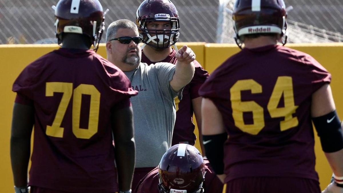 Former Minnesota offensive coordinator Matt Limegrover gives instruction to players during Gopher football practice in Minneapolis. Limegrover has been named Penn State’s new offensive line coach.