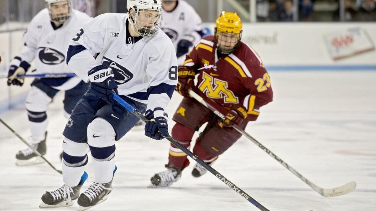 Penn State’s Chase Berger skates down the ice with the puck ahead of Minnesota defenders during the Saturday, January 9, 2016 game at Pegula Ice Arena. Minnesota won 7-1.