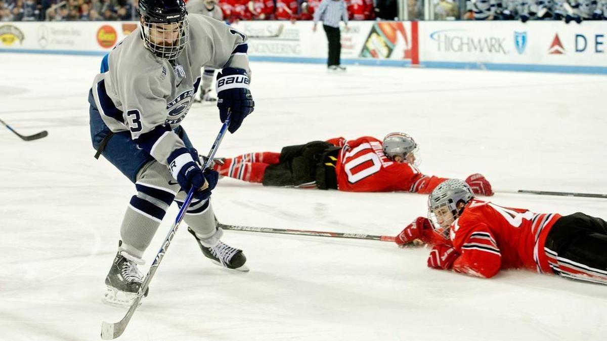 Ohio State defenders dive to block Penn State Kenny Brooks' shot during the Saturday, February 20, 2016 game at Pegula Ice Arena. Ohio State won, 7-4.