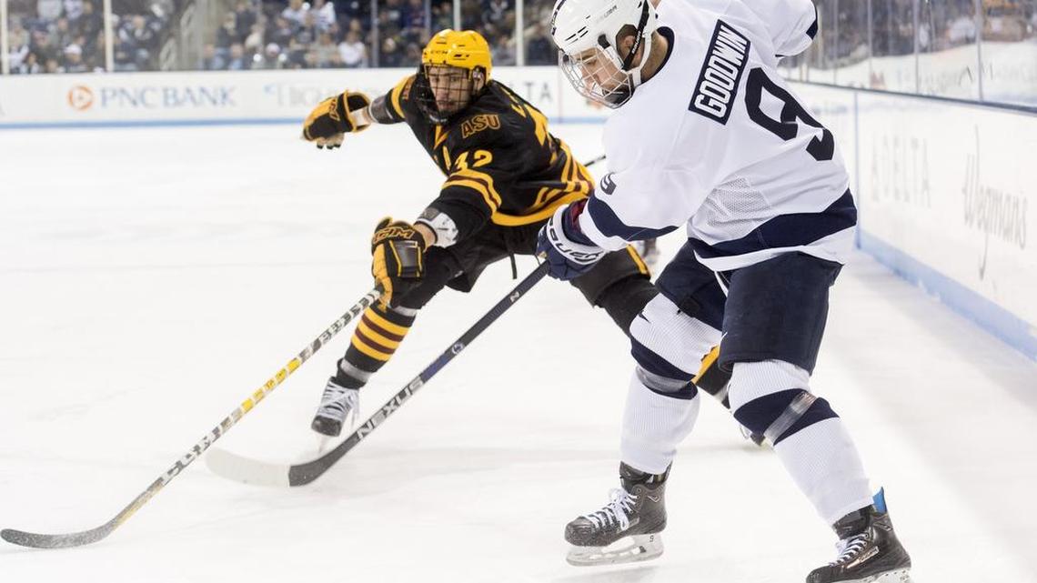 Penn State’s David Goodwin passes the puck around Arizona State’s Louie Rowe during Saturday’s game at Pegula Ice Arena.