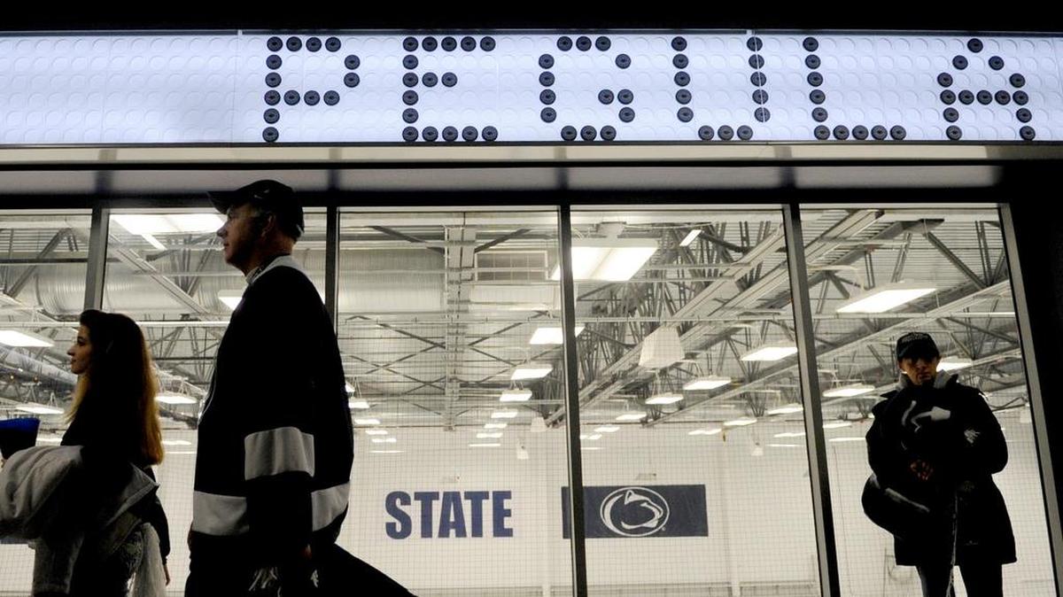 Fans walk around the concourse of Pegula Ice Arena for opening night on Oct. 11, 2013. The pucks used to spell out ‘Pegula’ are from youth hockey leagues around Pennsylvania.