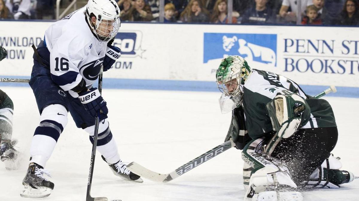 Penn State's Andrew Sturtz scores against Michigan State goalie Jake Hildebrand during a men's hockey game on Friday, Dec. 4, 2015.