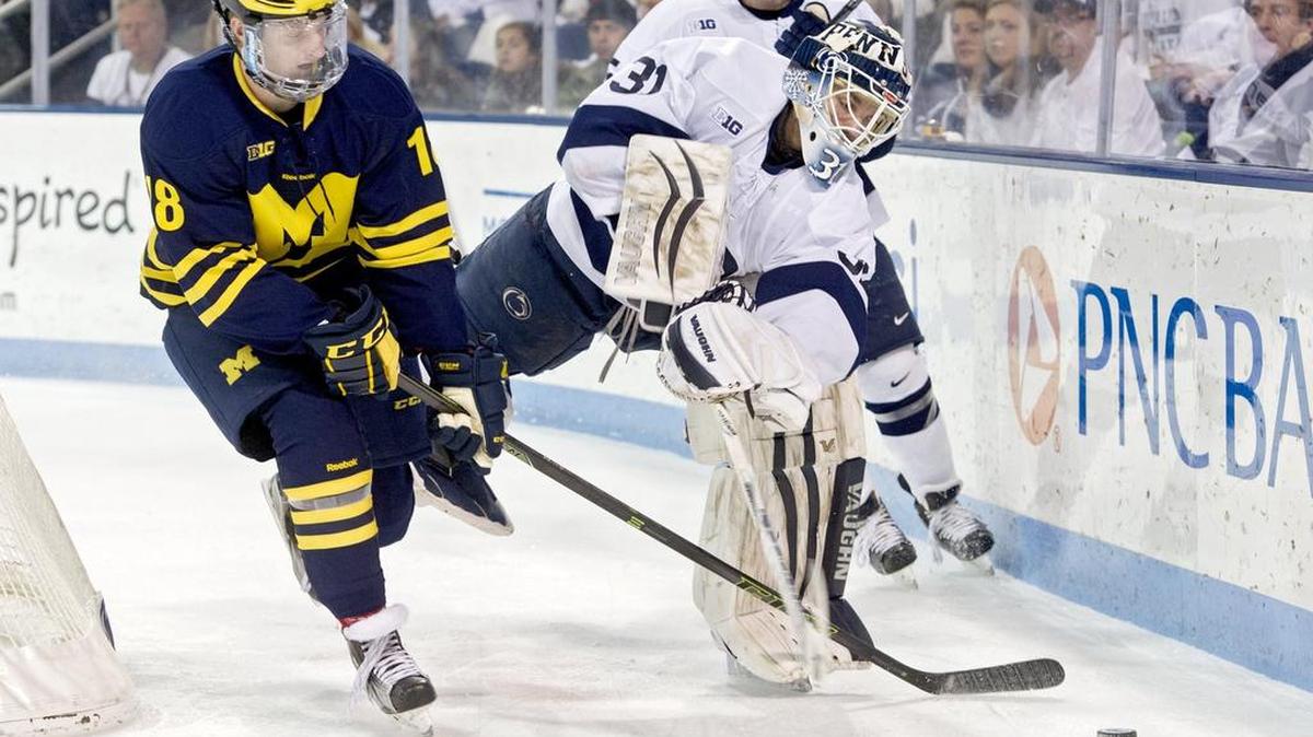 Penn State goalie Matthew Skoff clears the puck from Michigan's Kyle Connor during the Thursday, January 28, 2016 game at Pegula Ice Arena. Michigan won, 7-4.