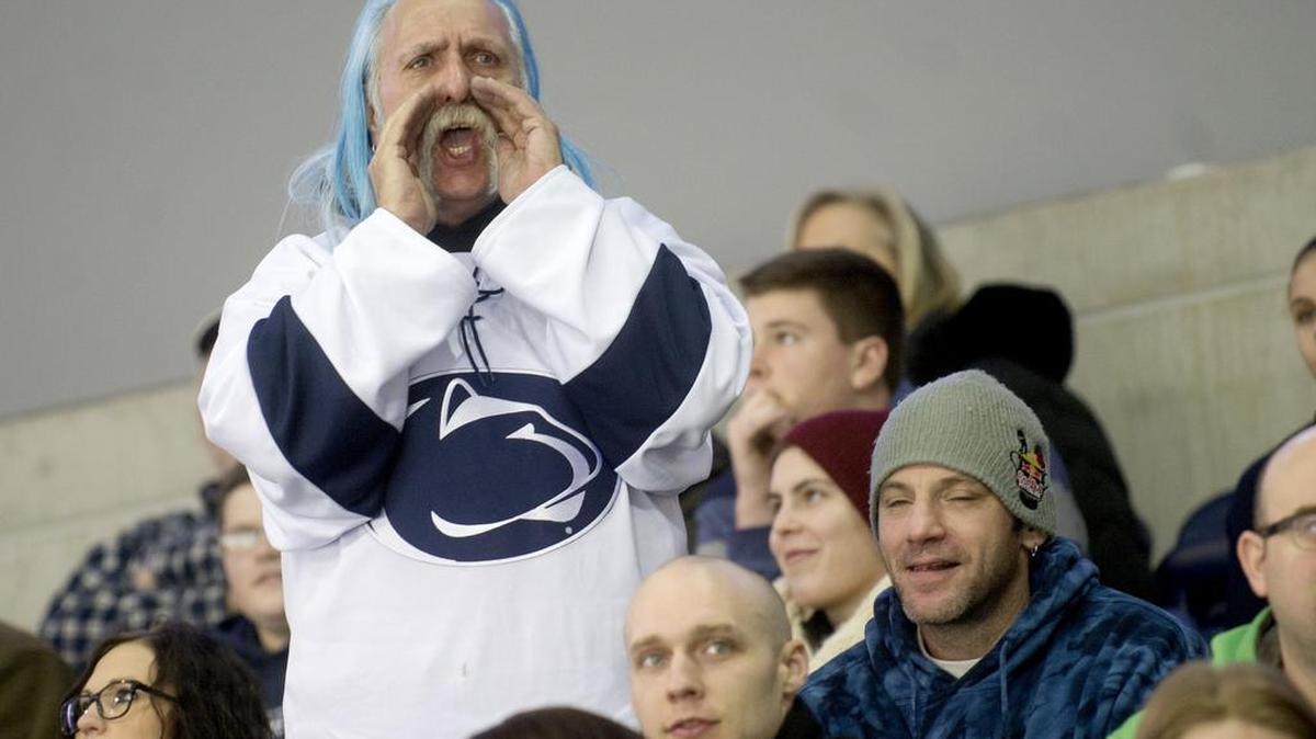 Rich Seifert leads the “We Are” chant during a Penn State hockey game in Pegula Ice Arena. Seifert, an avid hockey fan, uses blue mousse in his hair on hockey weekends to support and promote the team.