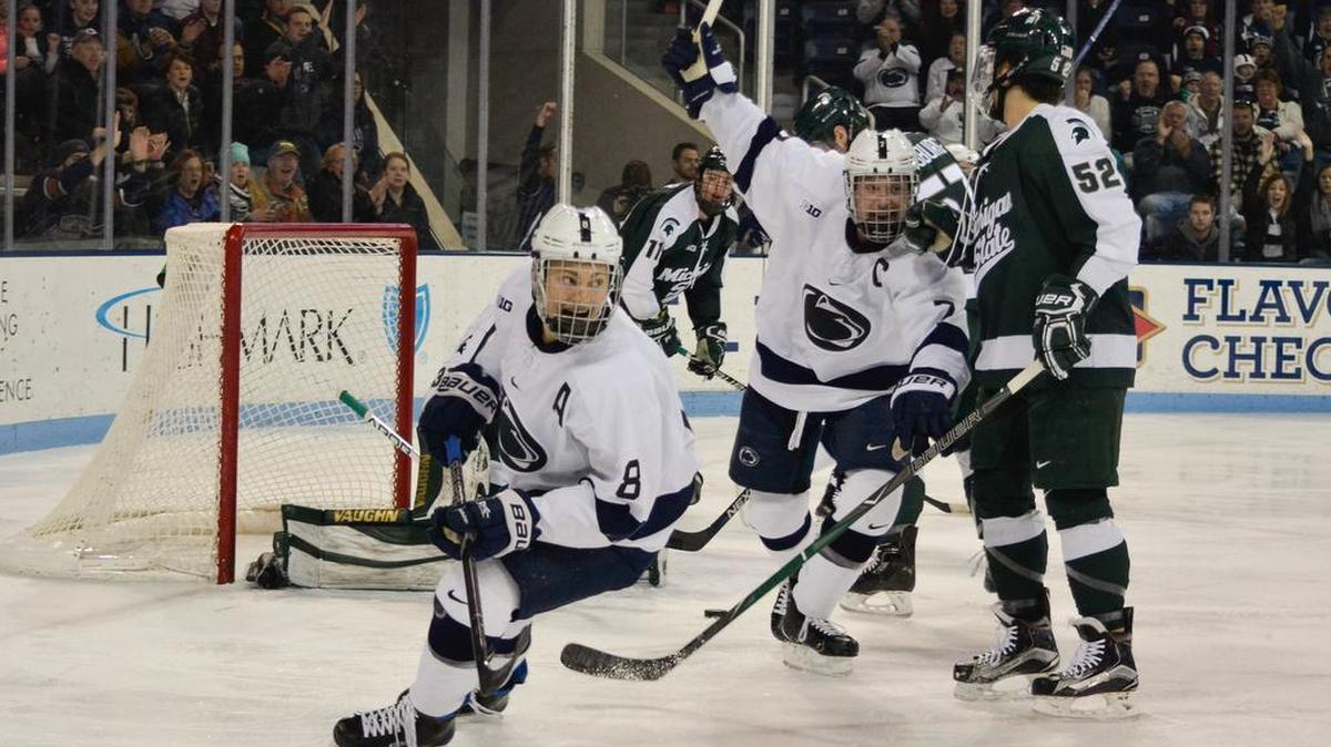 Penn State’s Chase Berger (8) and James Robinson (7) celebrate Kris Myllari’s goal one minute into Friday’s 7-2 victory over Michigan State at Pegula Ice Arena.