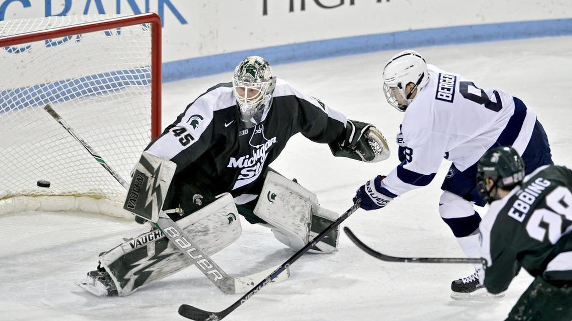 Penn State’s Chase Berger gets a goal around Michigan State’s Ed Minney in the first period of Friday’s game at Pegula Ice Arena.
