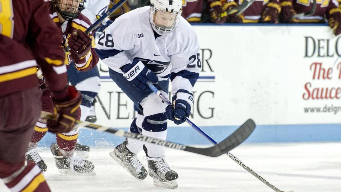 Penn State’s Alex Marsh skates down the ice with the puck around Minnesota defenders during the Friday, January 8, 2016 game at Pegula Ice Arena. Penn State won, 3-2.