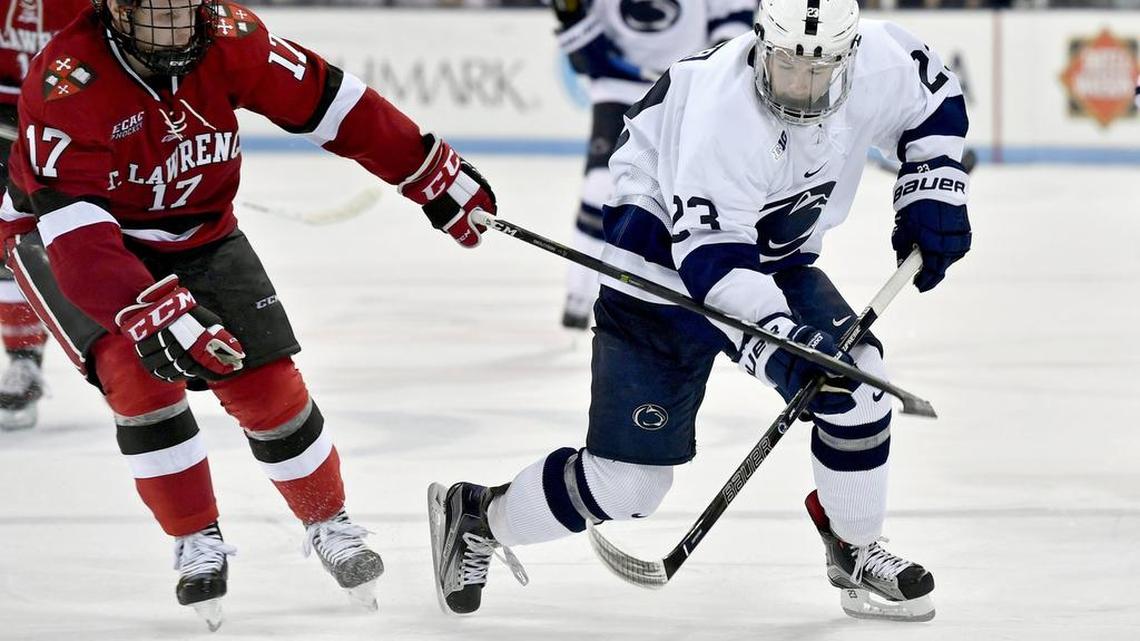 Penn State’s Blake Gober skates down the ice with the puck around St. Lawrence’s Drew Smolcynski during the season opener on Oct. 6 at Pegula Ice Arena.