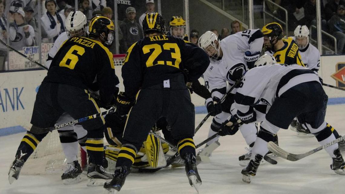 Penn State’s Andrew Sturtz, right, scores one of his two goals in front of a scrum in the Nittany Lions’ 6-1 win over Michigan on Thursday night at Pegula Ice Arena.