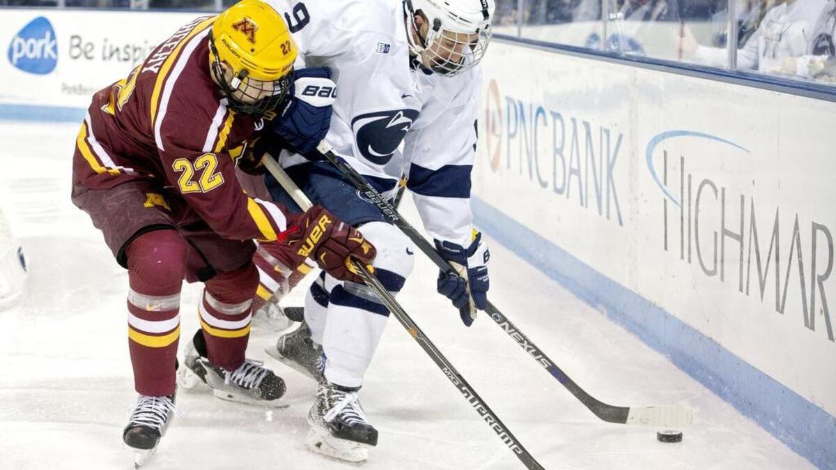 Minnesota’s Tyler Sheehy and Penn State’s David Goodwin fight for the puck during the game at Pegula Ice Arena on Staurday. Minnesota won 7-1.