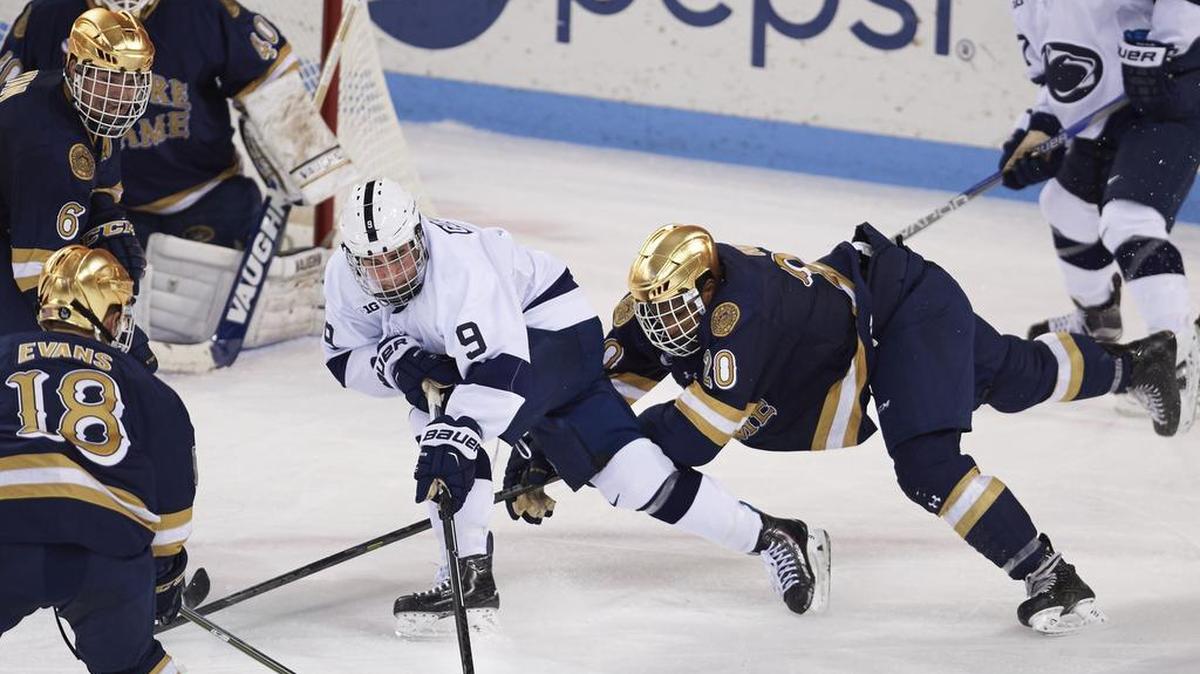 Penn State’s David Goodwin, center, battles for the puck during a game against Notre Dame on Oct. 16, 2015 at Pegula Ice Arena. Multiple reports say Notre Dame will join the Big Ten for hockey in 2017-18.