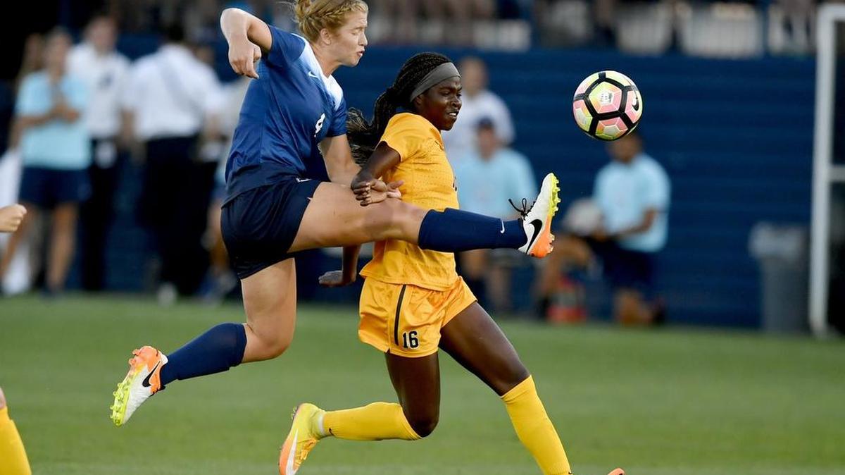 Above: Penn State’s Megan Schafer takes a shot on goal around West Virginia’s Easther Mayi Kith (16) during the Nittany Lions’ season opener on Friday. The teams played to a 1-1 tie. Below: Penn State’s Frannie Course (9) and West Virginia’s Amandine Pierre-Louis fight for the ball