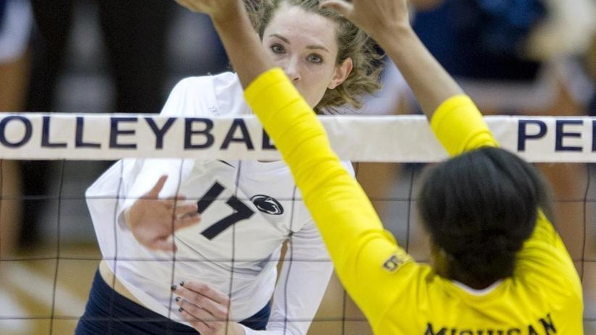 Penn State's Megan Courtney hits the ball over Michigan's Krystalyn Goode during the Wednesday, November 18, 2015 volleyball match in Rec Hall. Michigan won 3 sets to 1.