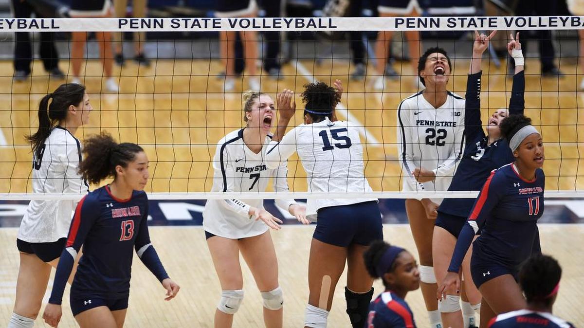 Penn State volleyball team members react after getting a point during a game against Howard Friday at Rec Hall.