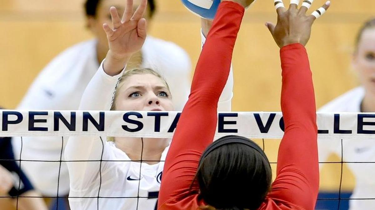 Penn State's Abby Detering and Nebraska's Briana Holman both try to hit the ball at the net during a match last season in Rec Hall.