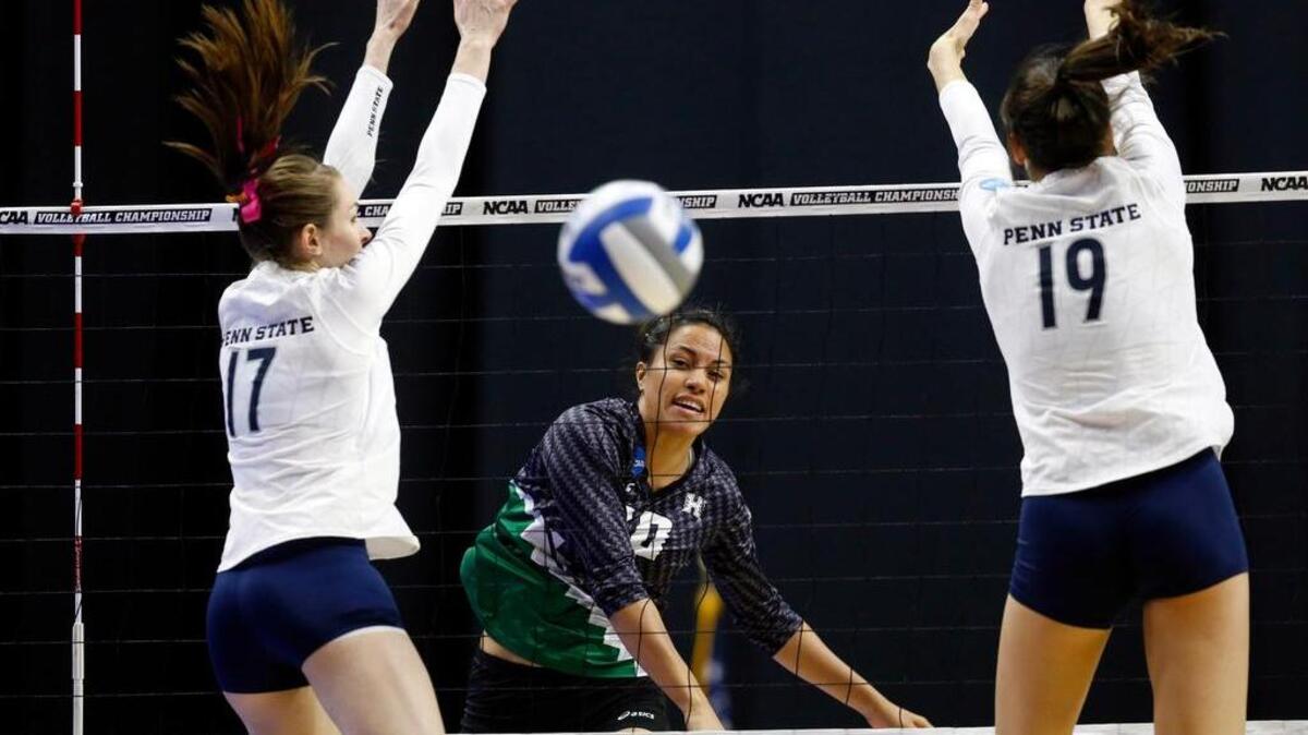 Hawaii's Tai Manu-Olevao (10) spikes the ball past Penn State's Megan Courtney (17) and Penn State's Heidi Thelen (19) Friday, Dec. 11, 2015, during the first round of the NCAA Division I Women's Volleyball Championship in Des Moines, Iowa.