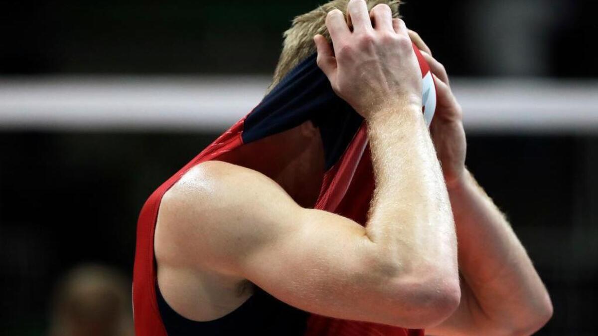 United States middle blocker and former Penn State All-American Maxwell Holt hides his face in his jersey after losing 3-2 to Italy a men's semifinal Olympic volleyball match on Friday in Rio de Janeiro.