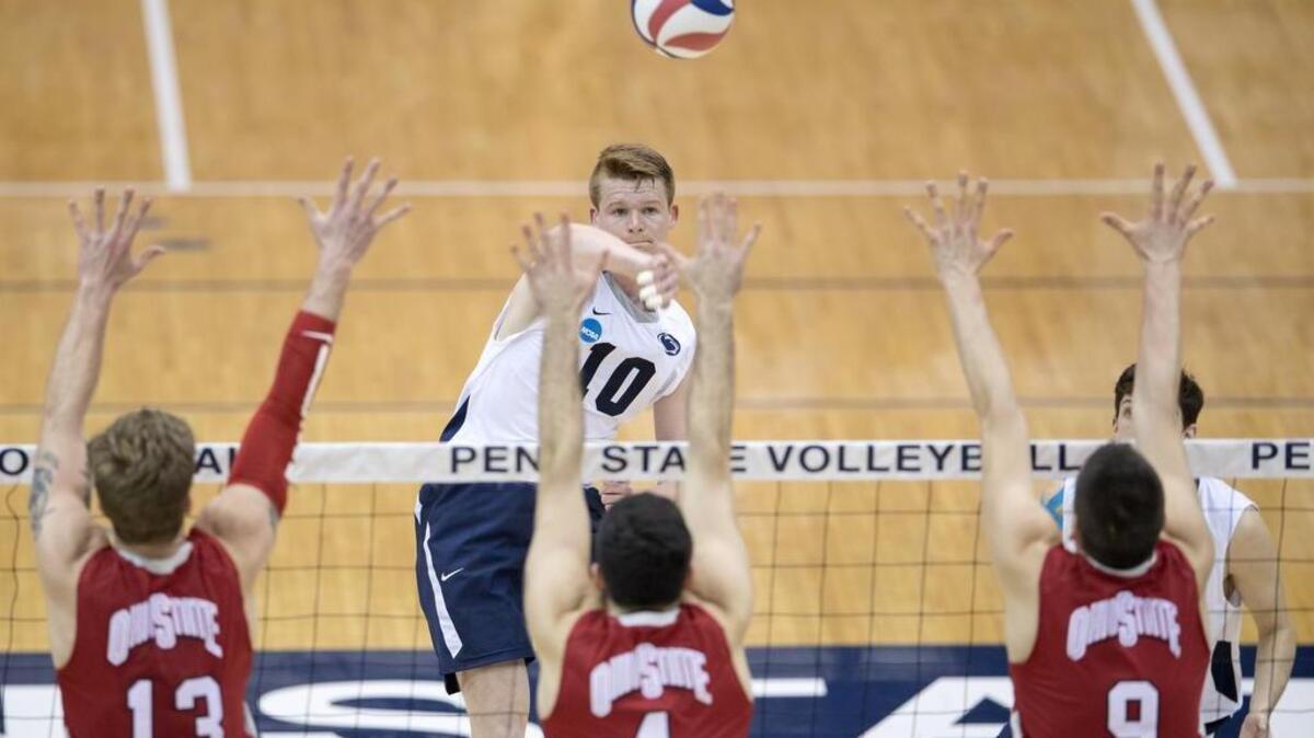 Penn State's Chris Nugent hits the ball over Ohio State defenders during the match on Tuesday, March 28, 2017 at Rec Hall. Penn State won in five sets.