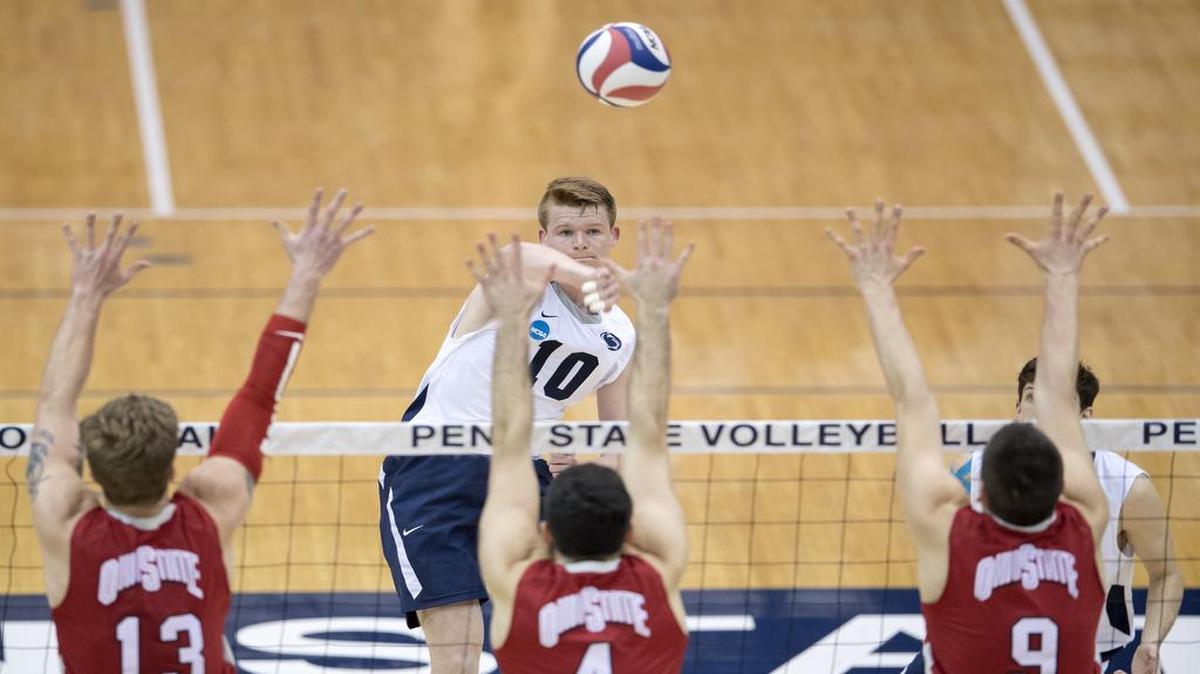 Penn State's Chris Nugent hits the ball over Ohio State defenders during the match on Tuesday, March 28, 2017 at Rec Hall. Penn State won in five sets.