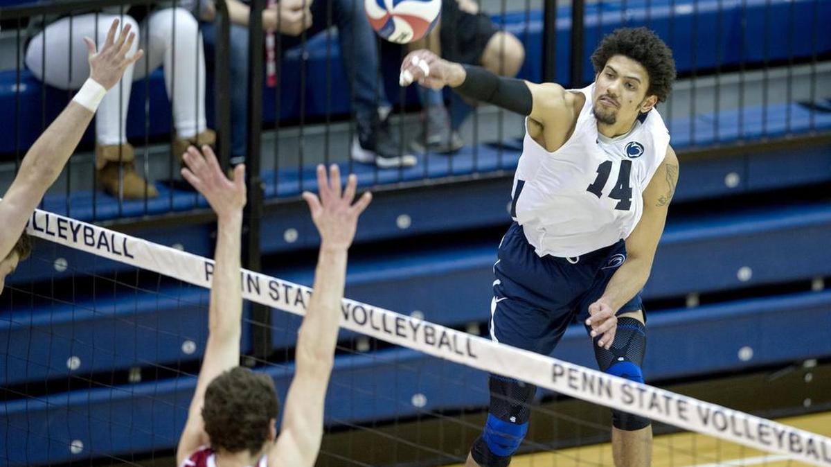 Penn State's Jalen Penrose hits the ball over Harvard defenders during the Friday, April 8, 2016 match in Rec Hall. Penn State won 3-0.