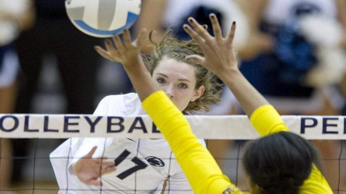 Penn State's Megan Courtney hits the ball over Michigan's Krystalyn Goode during the Wednesday, November 18, 2015 volleyball match in Rec Hall. Michigan won 3 sets to 1.