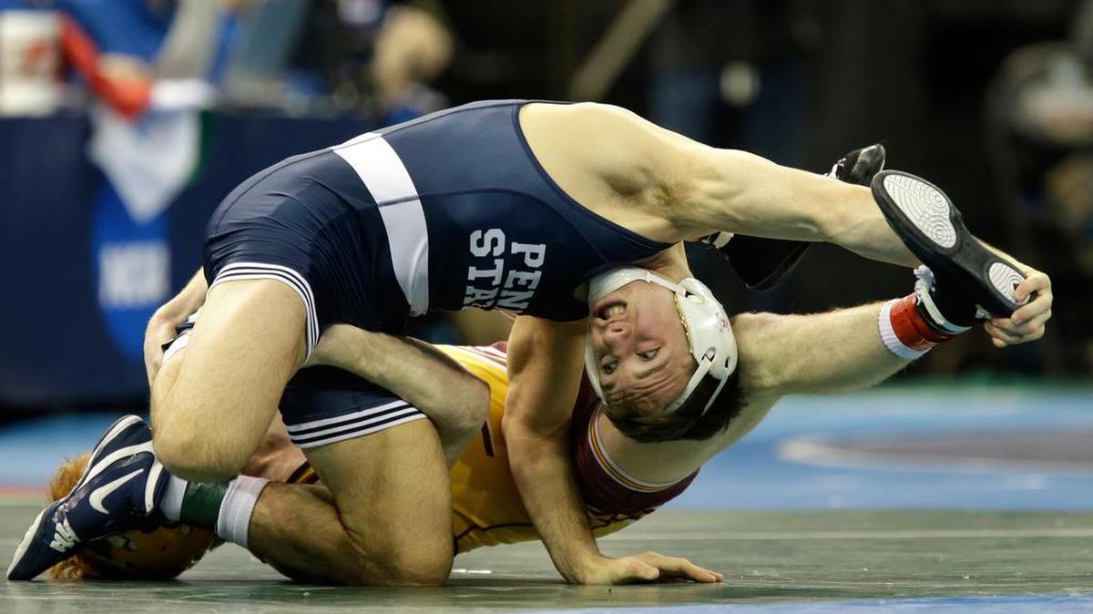 Penn State’s Zain Retherford, top, grapples with Central Michigan’s Justin Oliver in a 149-pound match during the NCAA Division 1 wrestling championship in New York on Friday. Penn State wrestling fans lucky enough to secure the hottest tickets in town — to the NCAA Wrestling Championship — have the Penn State Wrestling Club to thank.