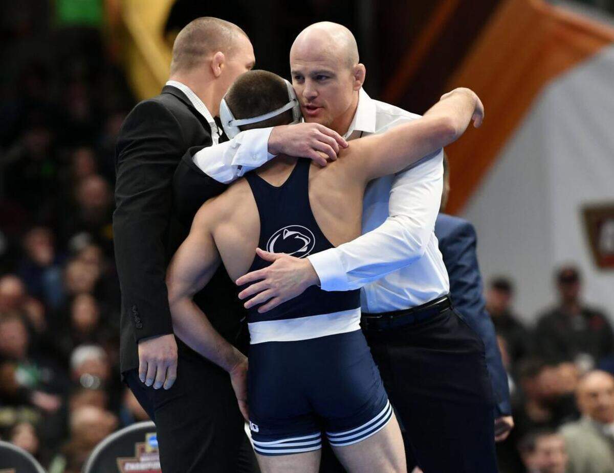 Penn State's Zain Retherford hugs head wrestling coach Cael Sanderson winning the national title at 149 pounds on March 17 at the NCAA Division I Wrestling Championships at the Quicken Loans Arena in Cleveland. With the win, Retherford became Penn State's second three-time national champ.