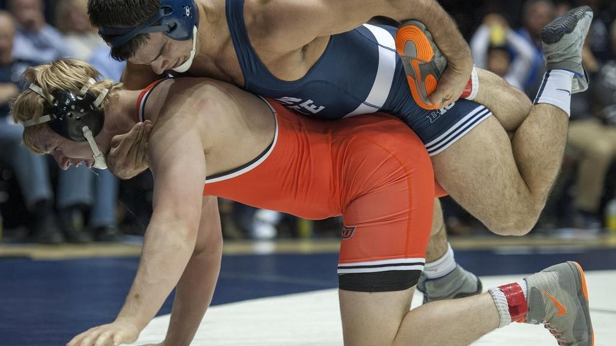 Penn State’s Morgan McIntosh grabs the foot of Oklahoma State’s Jacob Cooper during their 197-pound bout on Sunday during the Nittany Lions’ 29-18 win over the Cowboys. McIntosh pinned Cooper in 1:59 as Penn State won the National Dual Championship.