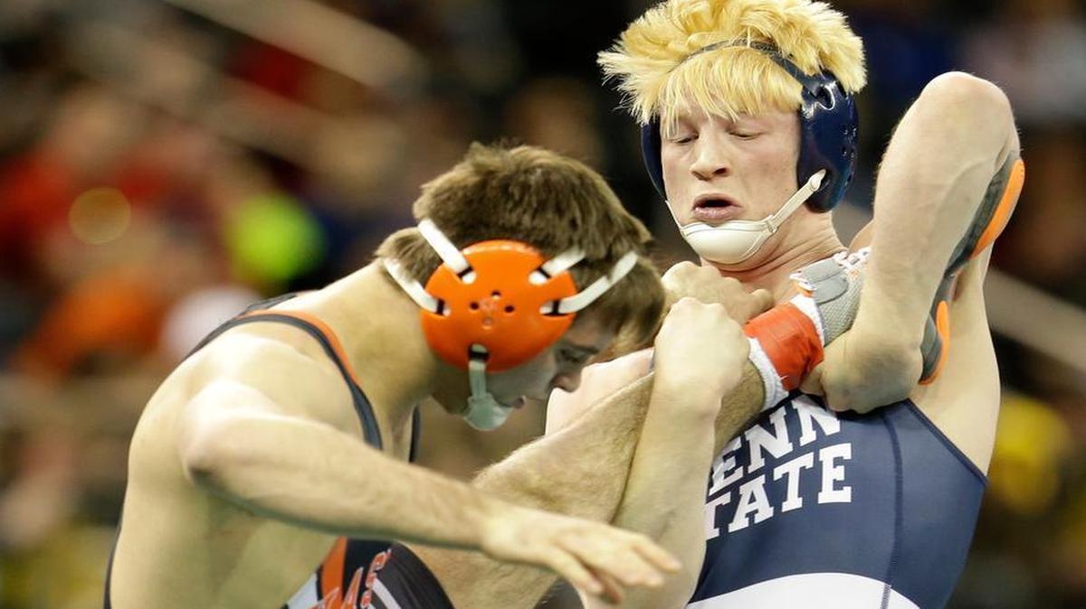 Penn State’s Bo Nickal, right, grabs the leg of Oklahoma State’s Chandler Rogers in their 174-pound match at the NCAA championships in New York on Friday.