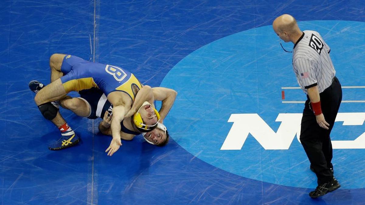 Penn State’s Zain Retherford, bottom, looks for back points on Cal State-Bakersfield’s Coleman Hammond in their 149-pound match at the NCAA Championship in New York on Thursday.