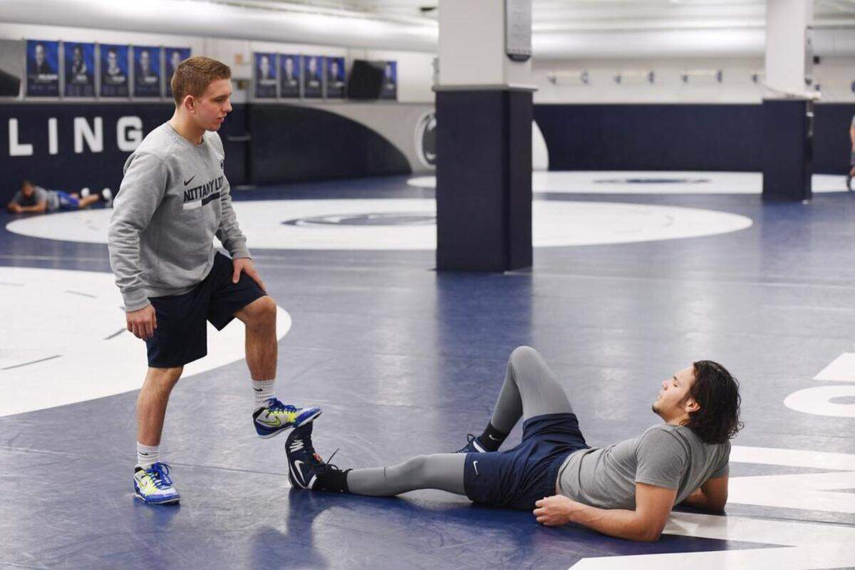 Zain Retherford helps stretch out teammate Shakur Rasheed at wrestling practice on Feb. 13 at the Lorenzo Wrestling Complex. "He's the nicest funniest kid -- hes' awesome. He's the most down-to-earth person I've ever met," Rasheed said about his teammate on the final day of this year's NCAA Division I Wrestling Championships.