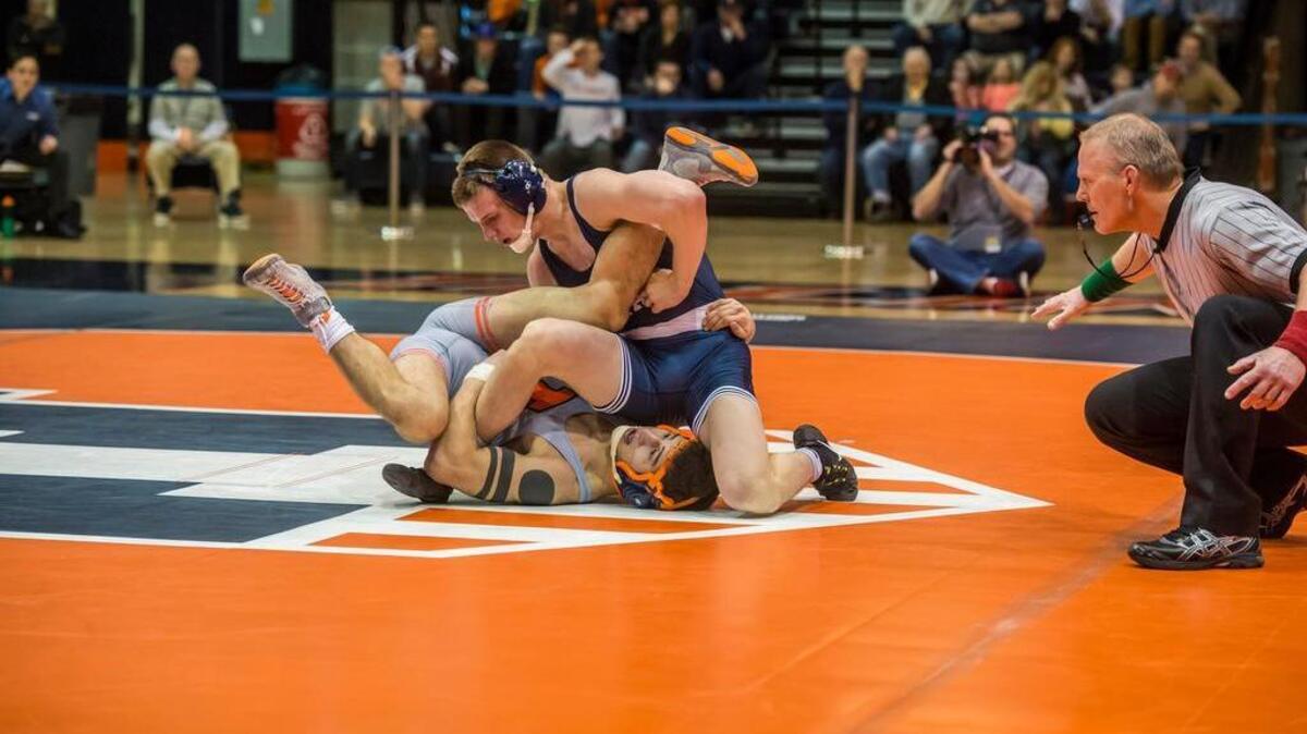 Penn State’s Jason Nolf puts Illinois’ previously unbeaten Isaiah Martinez on his back Saturday for a pin at 4:56.