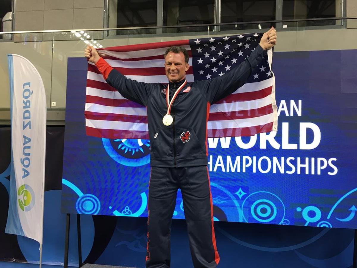 Former Penn State wrestler John Hanrahan celebrates on the podium after winning the 85-kilogram weight class of the Freestyle Veteran’s Category E World Championships in Poland in 2016.