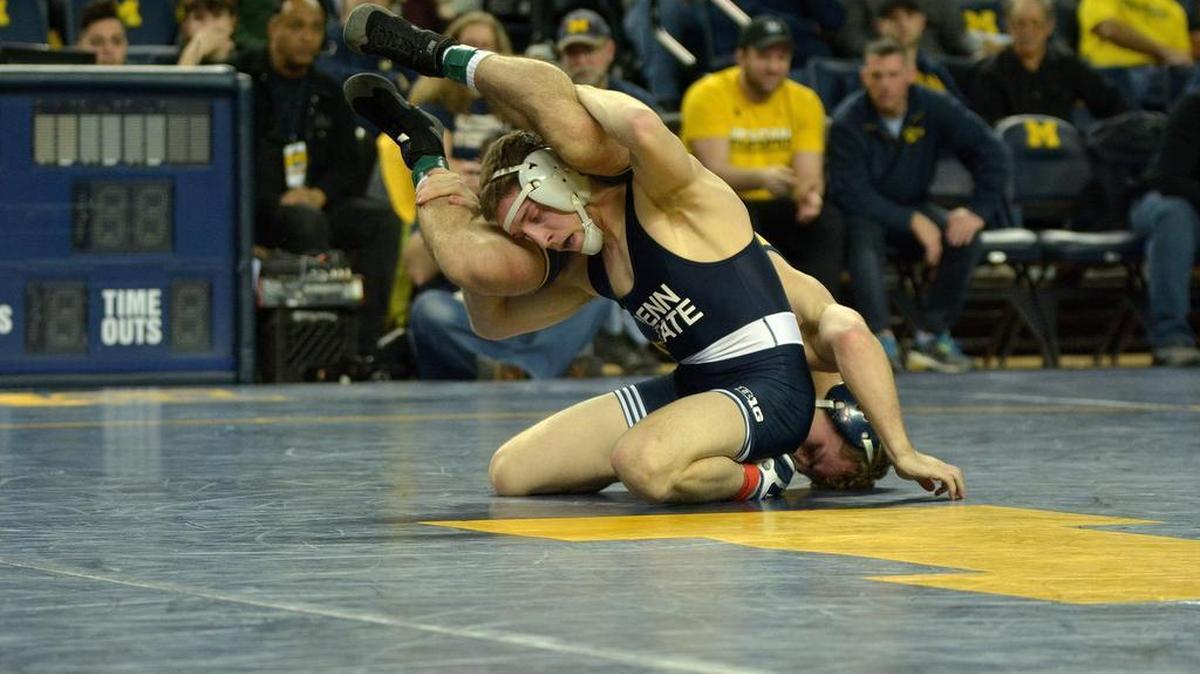 Penn State’s Nick Lee attempts to finish off a takedown of Michigan’s Sal Profaci in their 141-pound bout during the Nittany Lions’ 25-12 win on Friday night. Lee made his Penn State debut with a 9-5 win.