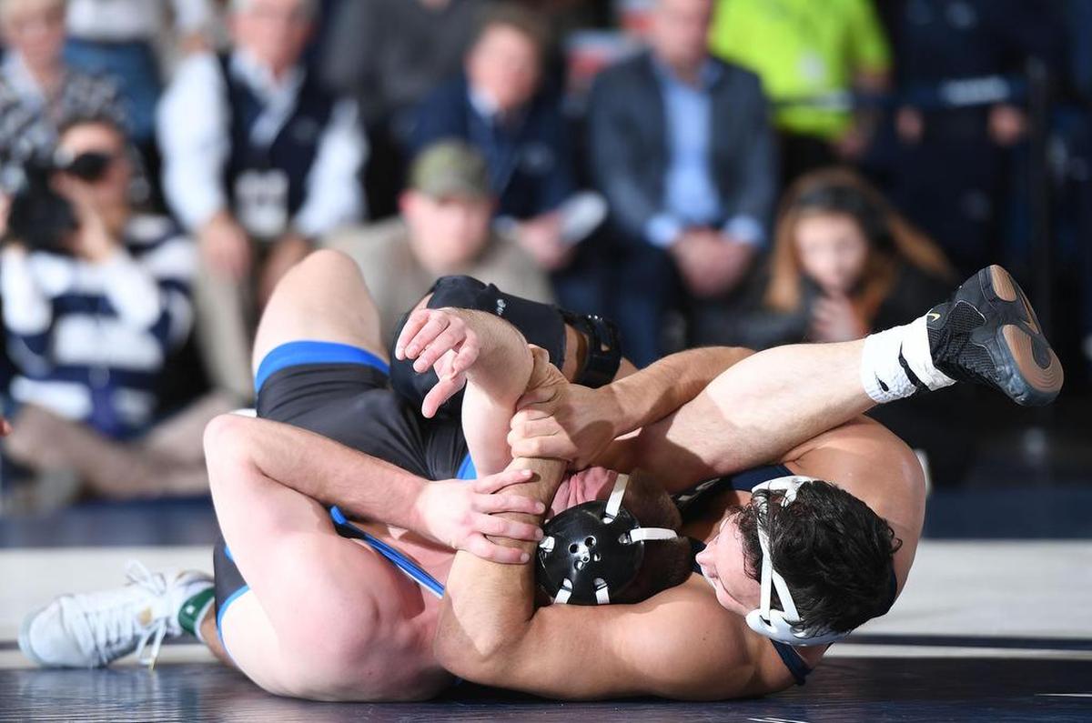 Penn State’s Shakur Rasheed (right) pins Buffalo’s Logan Rill Sunday at Recreational Hall. Penn State defeated Buffalo, 47-3.