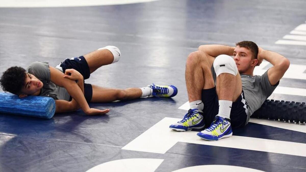 Penn State’s Justin Lopez, left, and Zain Retherford hang out during wrestling practice Tuesday, Nov. 28, 2017 at the Lorenzo Wrestling Complex.
