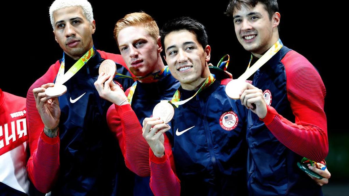 Penn State graduate Miles Chamley-Watson, left, helped the U.S. Fencing Team to its first medal on Friday, earning bronze in Rio.