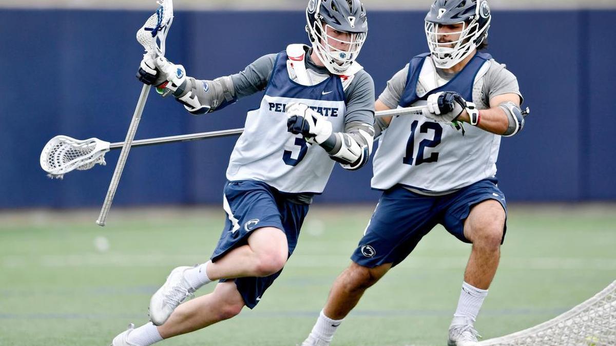 Penn State lacrosse freshman Mac O’Keefe runs around Tyler Butler during practice on Tuesday, February 28, 2017.