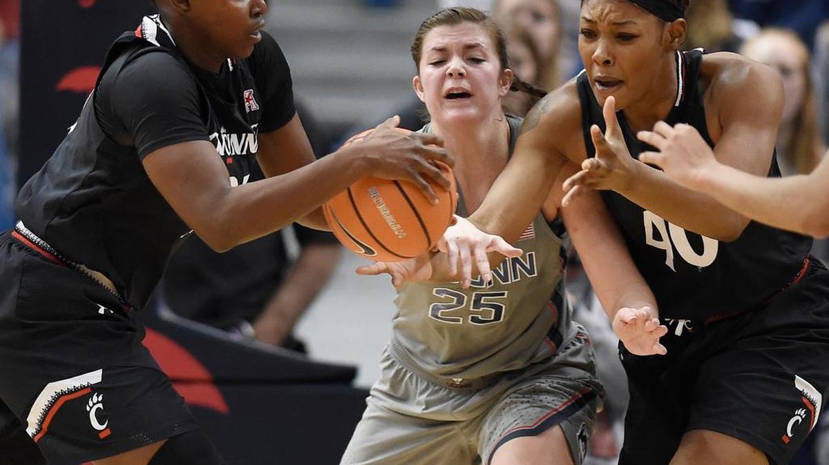 Connecticut’s Kyla Irwin, center, cuts between a pass from Cincinnati’s Shanice Johnson, left, to Cincinnati’s Andeija Puckett, right, during the second half of UConn’s 106-65 win Sunday, in Hartford, Conn. Irwin, a State College graduate, had five points, five rebounds and five assists in the game.