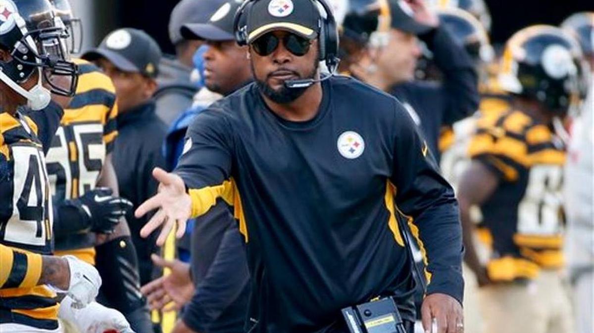 Pittsburgh Steelers head coach Mike Tomlin throws a challenge flag during an NFL football game against the Cincinnati Bengals in Pittsburgh.