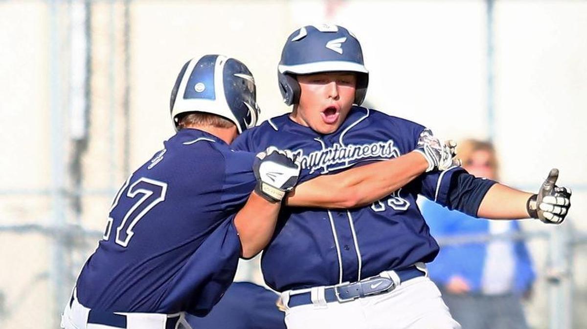 Phillipsburg-Osceola High School right-fielder Micah Martin (27) celebrates with designated hitter Isaac Knepp (13) after winning their home playoff game in the bottom of the tenth inning against Chestnut Ridge on Thursday, May 19, 2016.