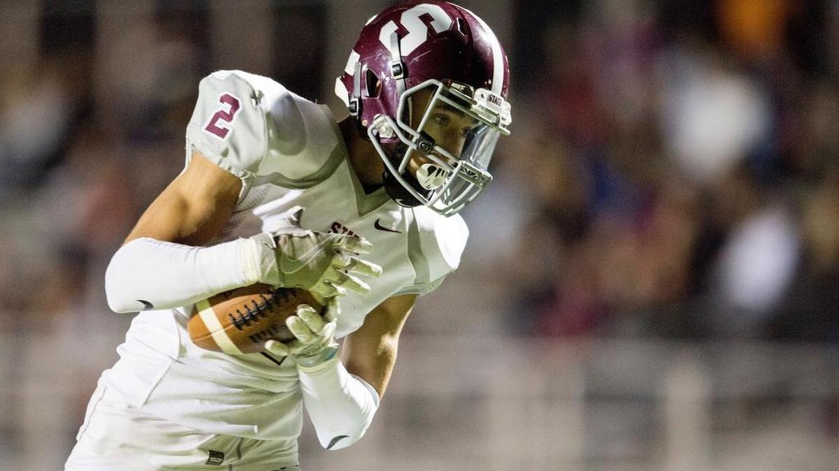 State College's Noah Woods makes a catch and runs it in for a touchdown around a McDowell defender during the Nov. 12 game at Clarion University. State College won, 35-14.