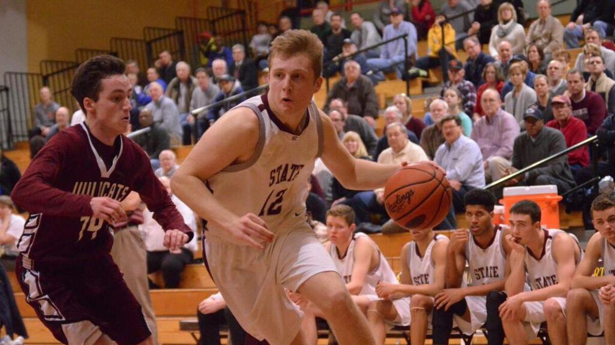 State College’s Drew Friberg drives to the basket against Mechanicsburg during the Mid Penn boys basketball championship game Thursday.