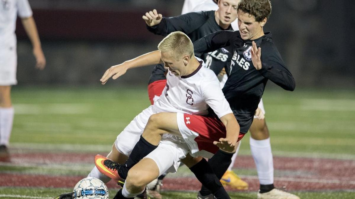 Cumberland Valley’s Dominic Nitecki trips up State College’s Eli Bokunewicz as they fight for the ball during the Tuesday, October 4, 2016 game at Memorial Field.