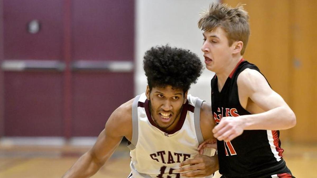 State College’s Brandon Clark pushes around Cumberland Valley’s Micah Wolf as he dribbles down the court Friday.