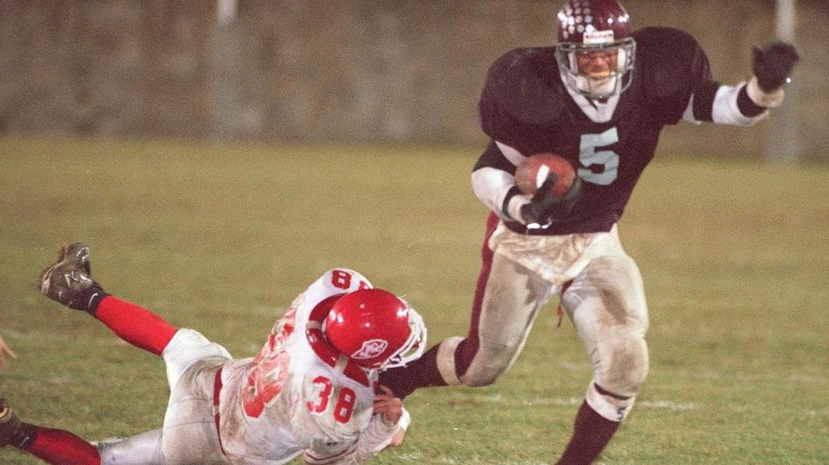 State College running back Larry Johnson (5) breaks a tackle as he goes in to score one of his five touchdowns as Punxsutawney’s Ryan Sandy misses a tackle during the Friday, Oct. 24, 1997 game. Johnson had 374 yards rushing on 31 carries in a 50-12 win.