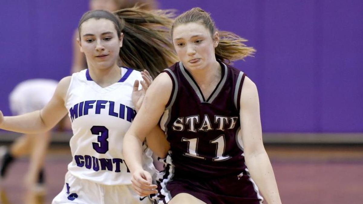 State College's Maya Bokunewicz dribbles down the court with the ball around Mifflin County’s Eleana Eckley during the Wednesday game at Mifflin County High School. State College won, 50-48.