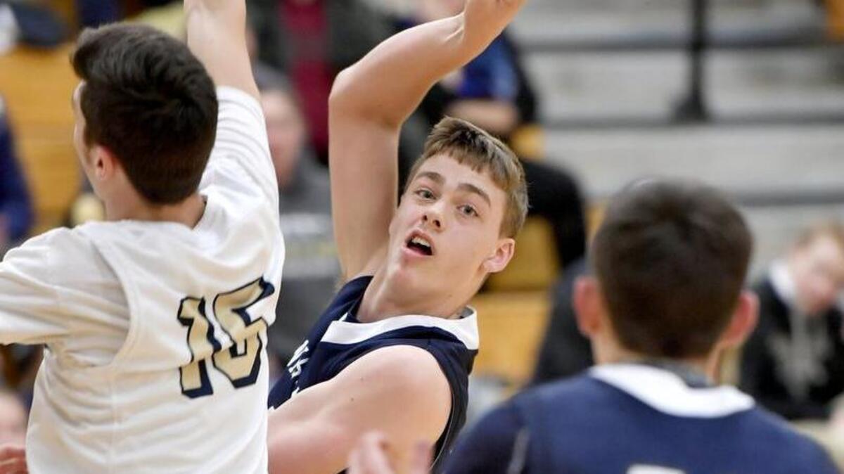 Penns Valley's Aaron Tobias passes the ball to a teammate around a Bald Eagle Area defender during the Tuesday, December 12, 2017 game. Bald Eagle Area won, 43-30.
